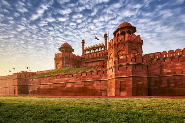 Red Fort Glowing under a Sunset Sky - Sky, Stars & Sunsets wallpaper