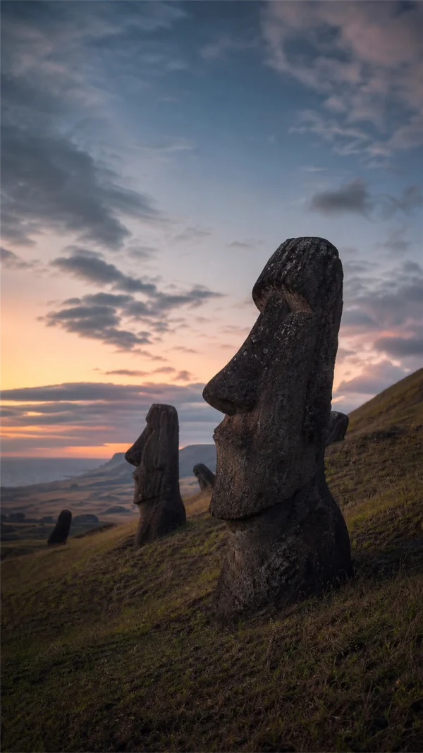 Stone Figures Lined Along the Dusk Hillside - Orange Phone - Heritage & Ruins / Sky, Stars & Sunsets wallpaper